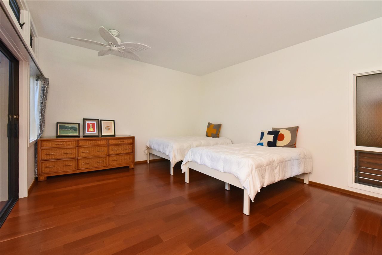 100 Ridge Road, Unit 2312 Lahaina, HI 96761 - Photo 18 of 30 a bedroom with a bed and a chandelier