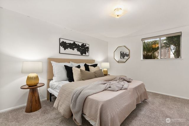 a bedroom with bed and wall painting