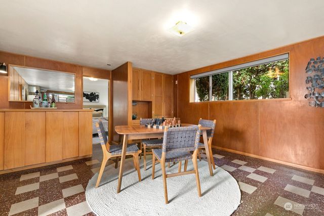 a dining room with furniture and window