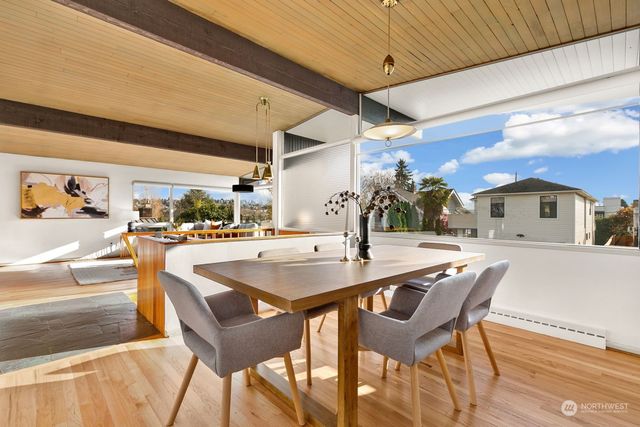 a kitchen with stainless steel appliances kitchen island a table and chairs in it