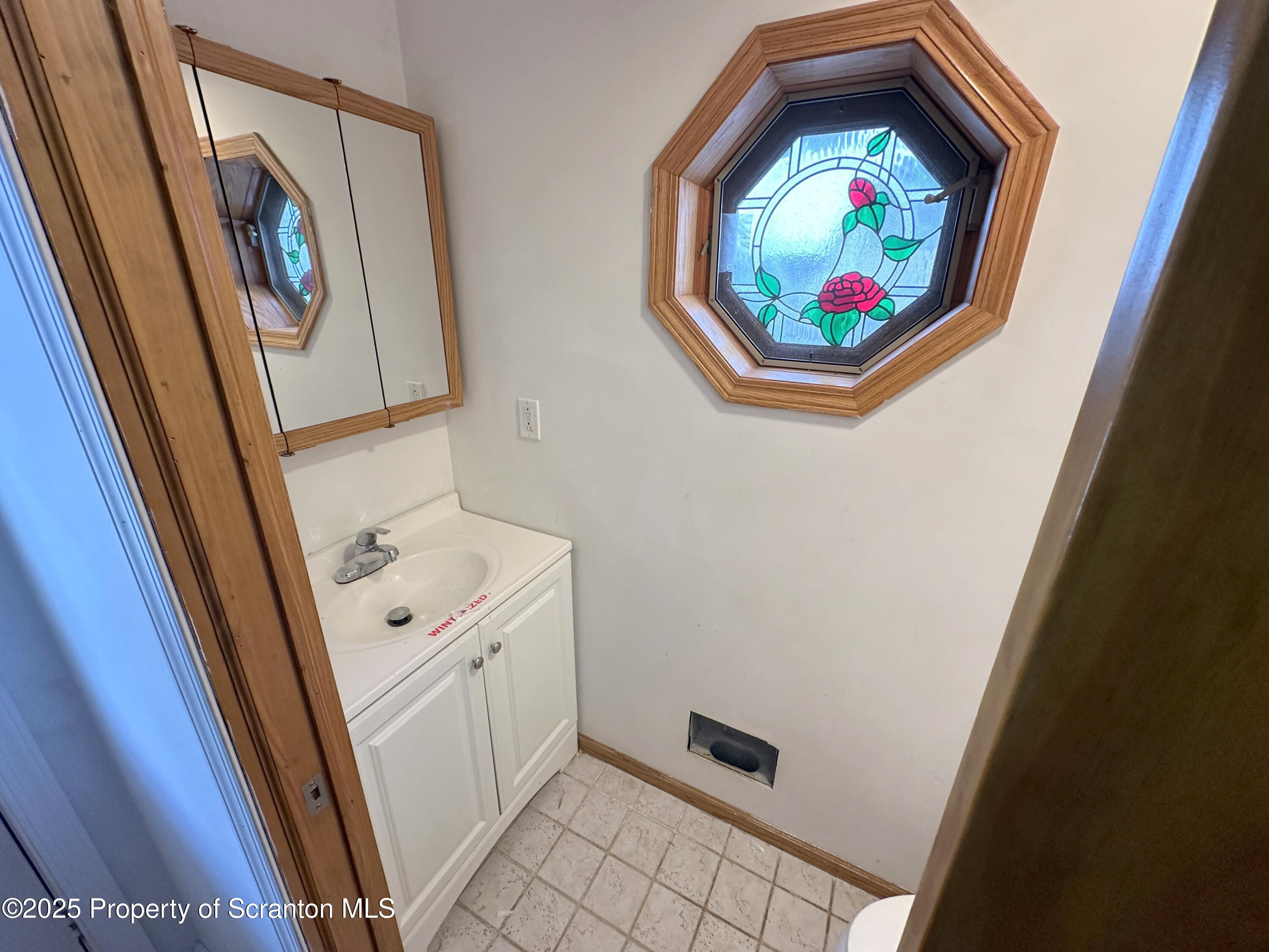 534 2nd Avenue Jessup, PA 18434 - Photo 5 of 14 a bathroom with a vanity and a mirror