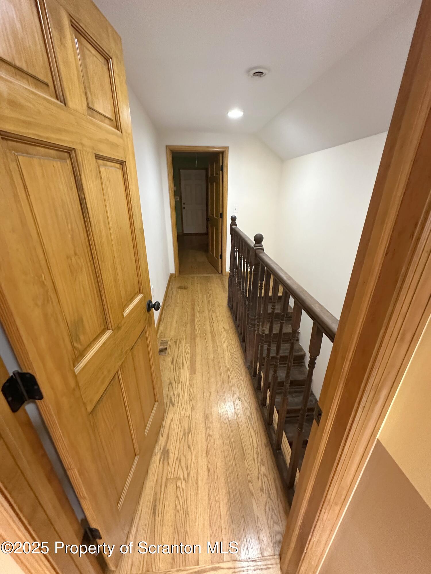 534 2nd Avenue Jessup, PA 18434 - Photo 6 of 14 a view of a hallway with wooden floor and staircase