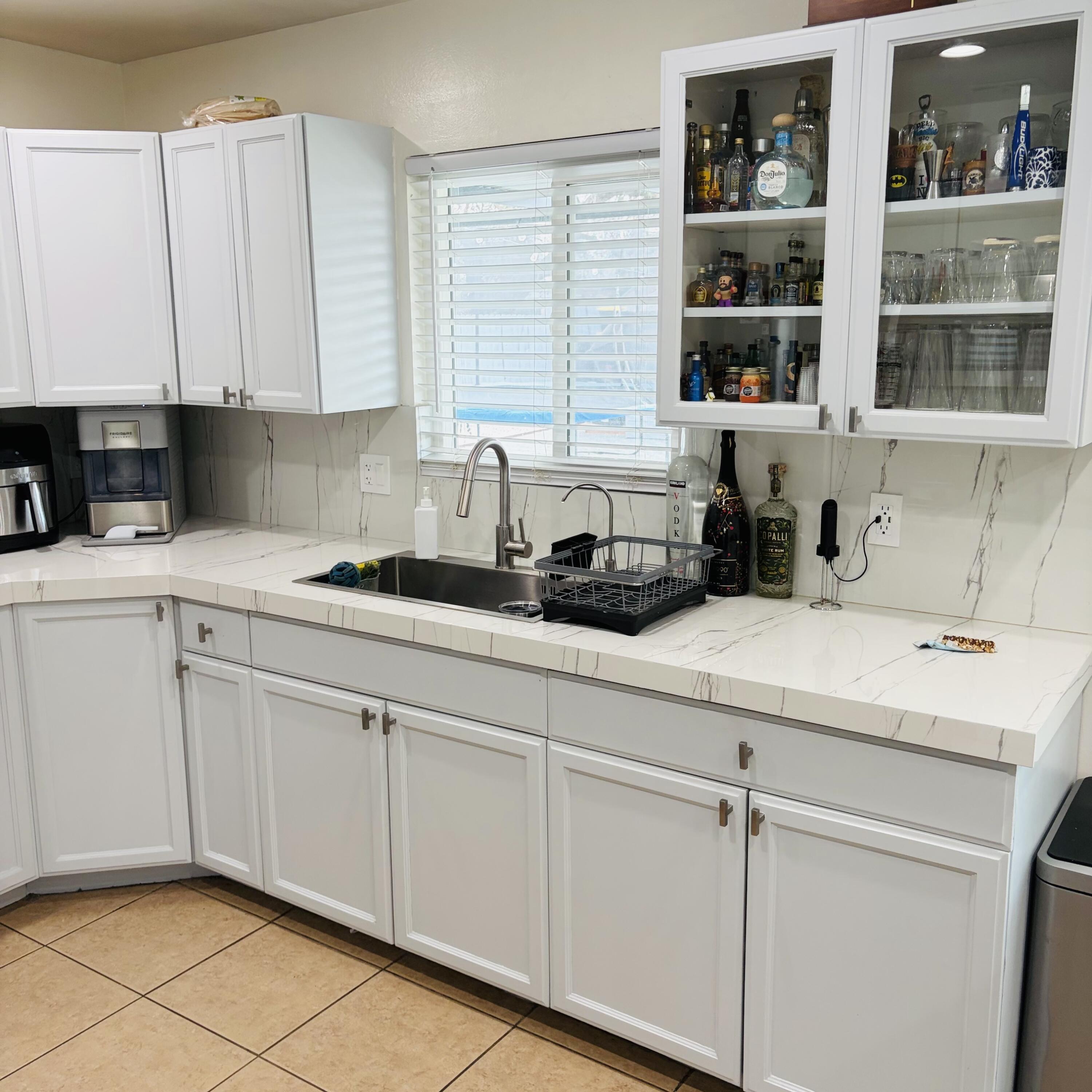 82165 Crest Avenue Indio, CA 92201 - Photo 12 of 37 a kitchen with a sink cabinets and window
