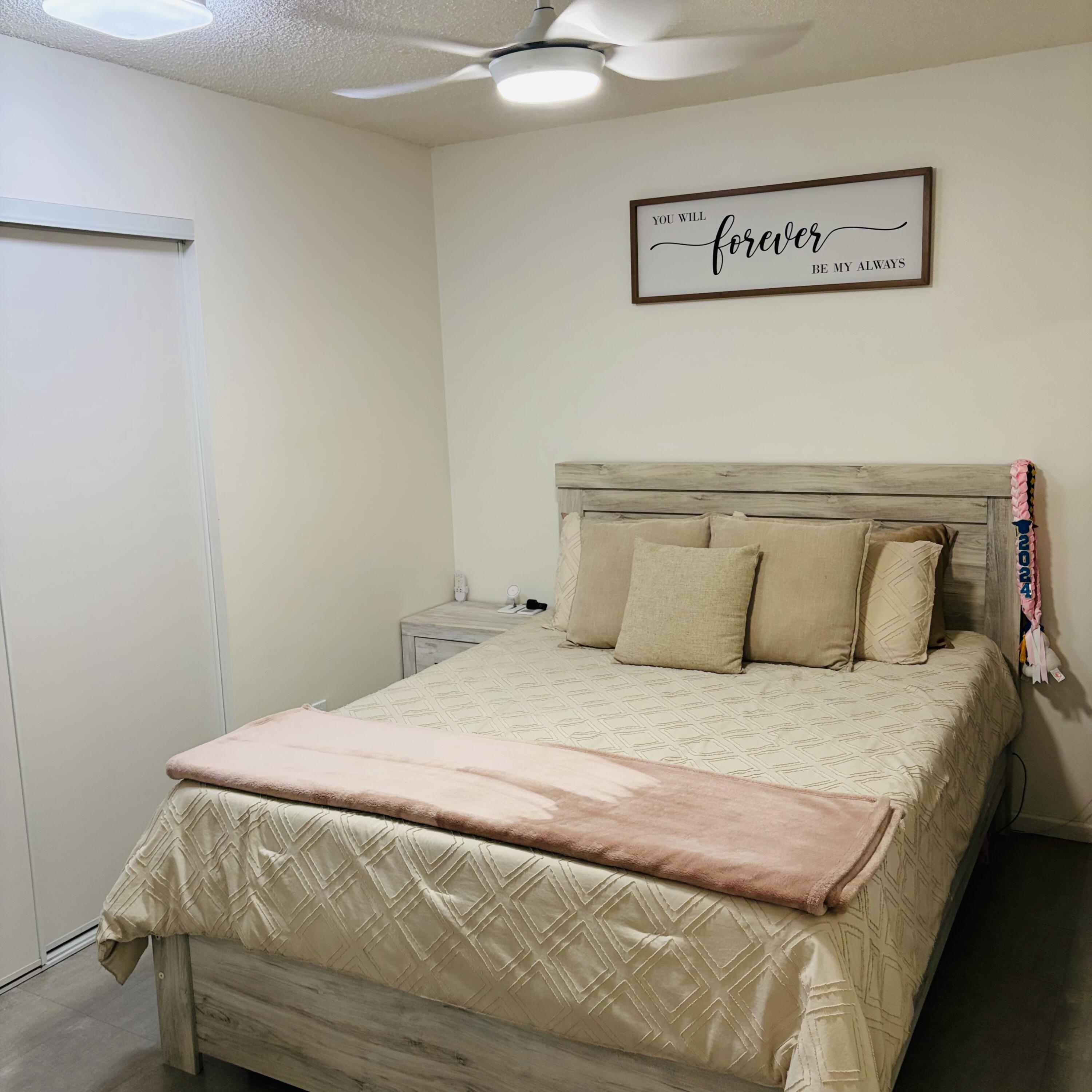 82165 Crest Avenue Indio, CA 92201 - Photo 14 of 37 a bedroom with a bed and painting on the wall