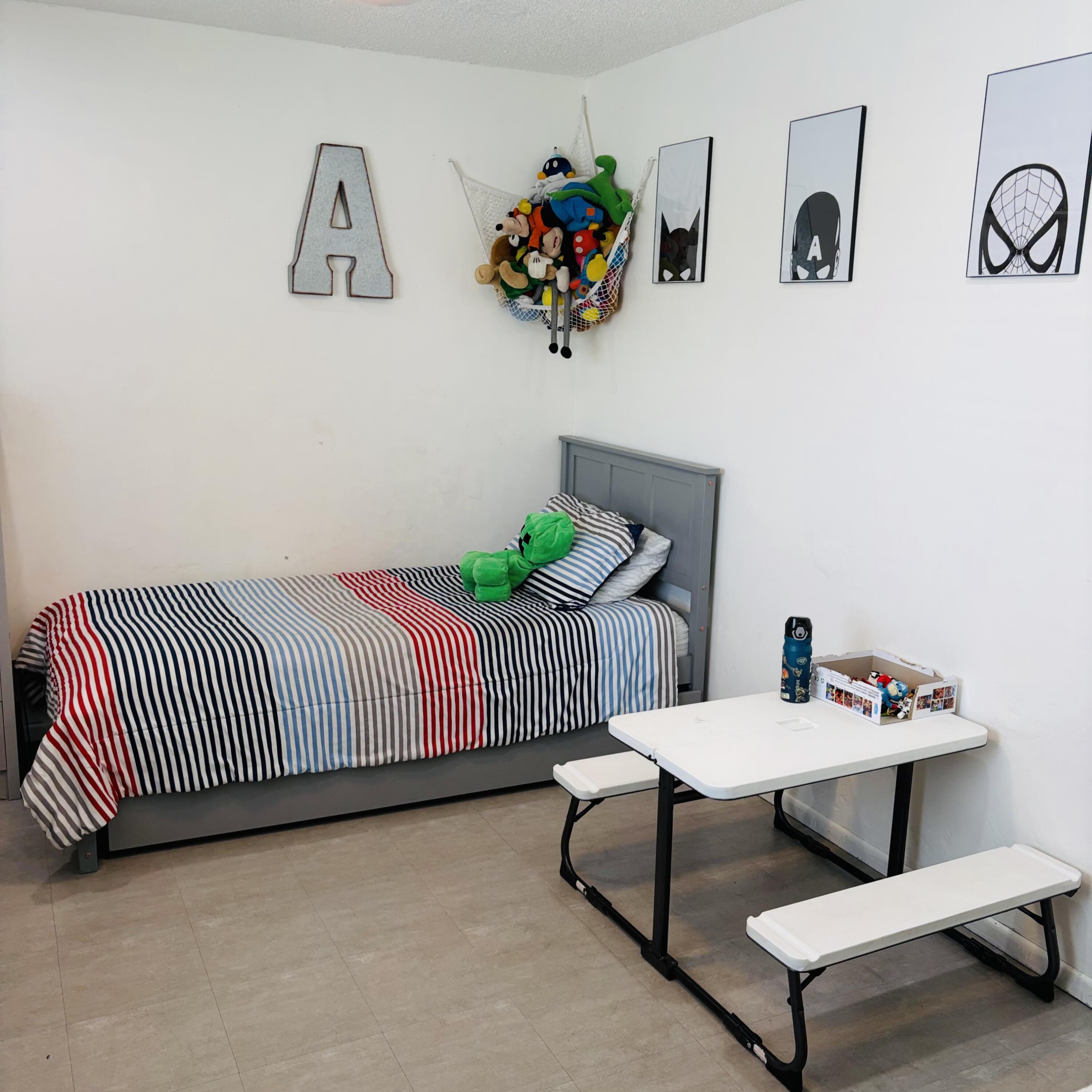 82165 Crest Avenue Indio, CA 92201 - Photo 21 of 37 a bedroom with furniture and a potted plant