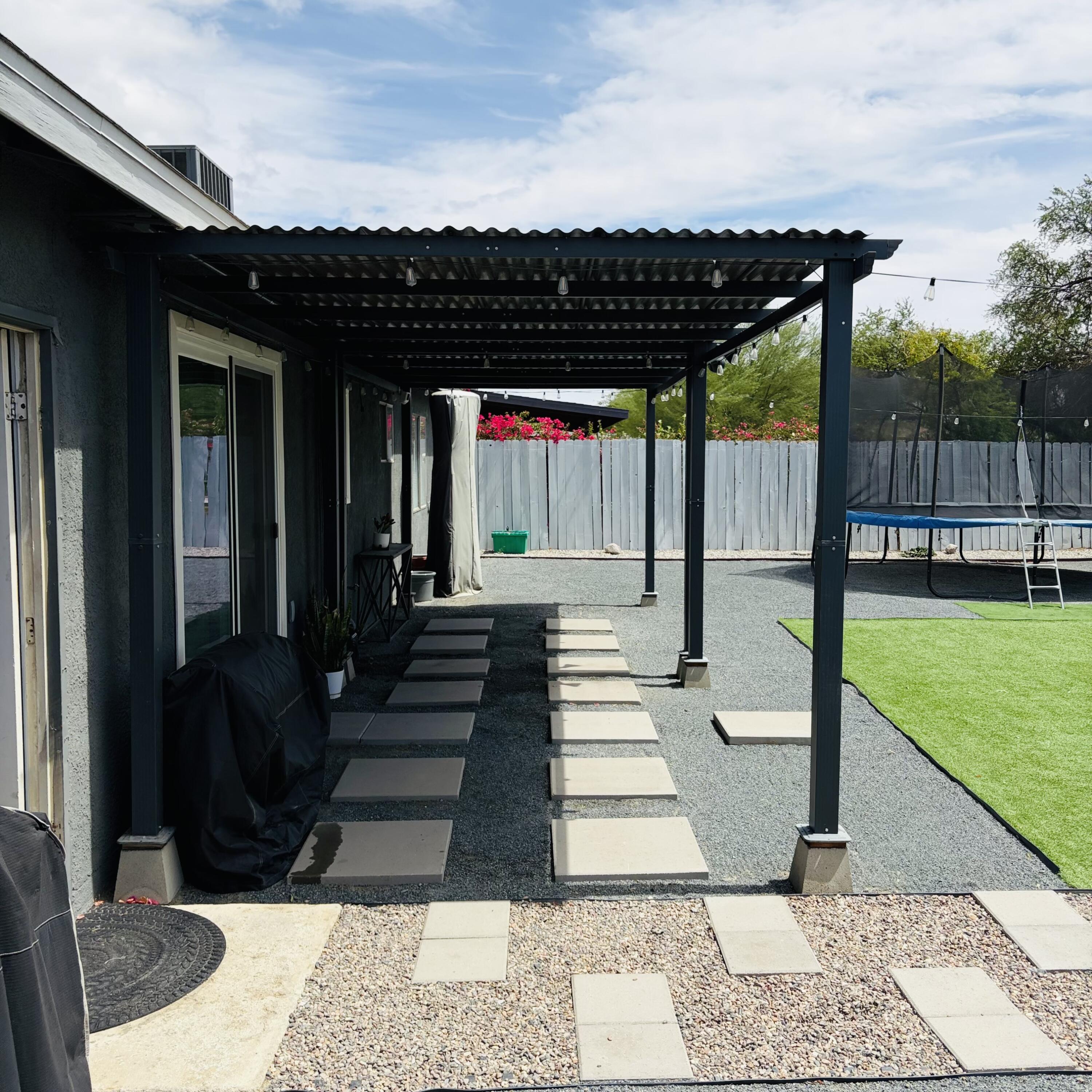 82165 Crest Avenue Indio, CA 92201 - Photo 30 of 37 a view of a patio with a table and chairs and potted plants