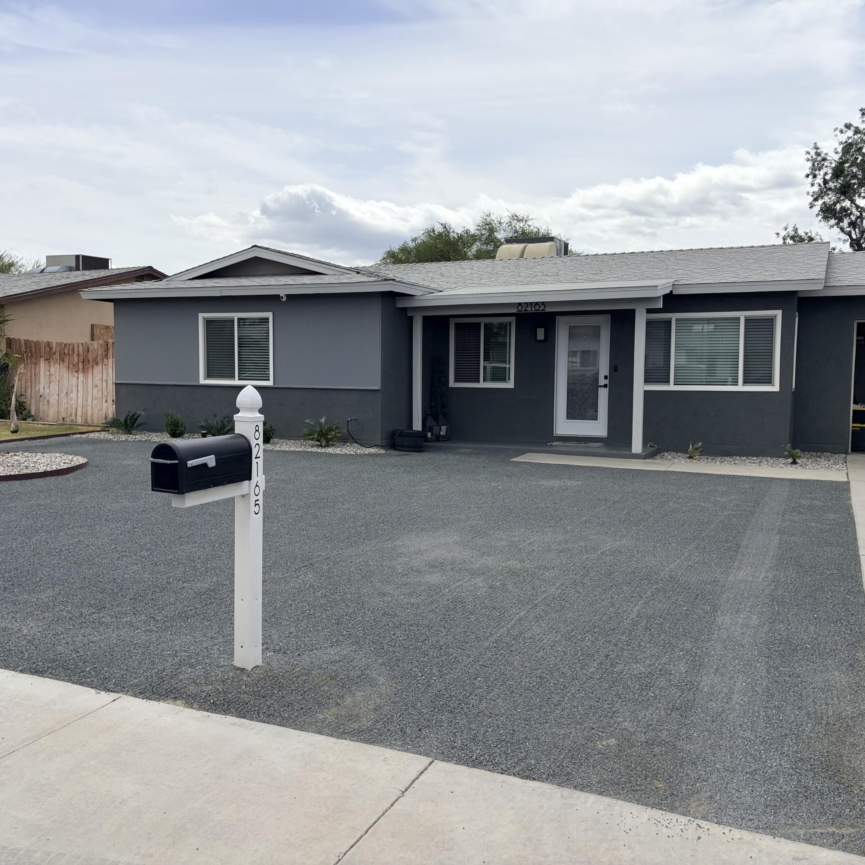 82165 Crest Avenue Indio, CA 92201 - Photo 3 of 37 a front view of a house with parking space