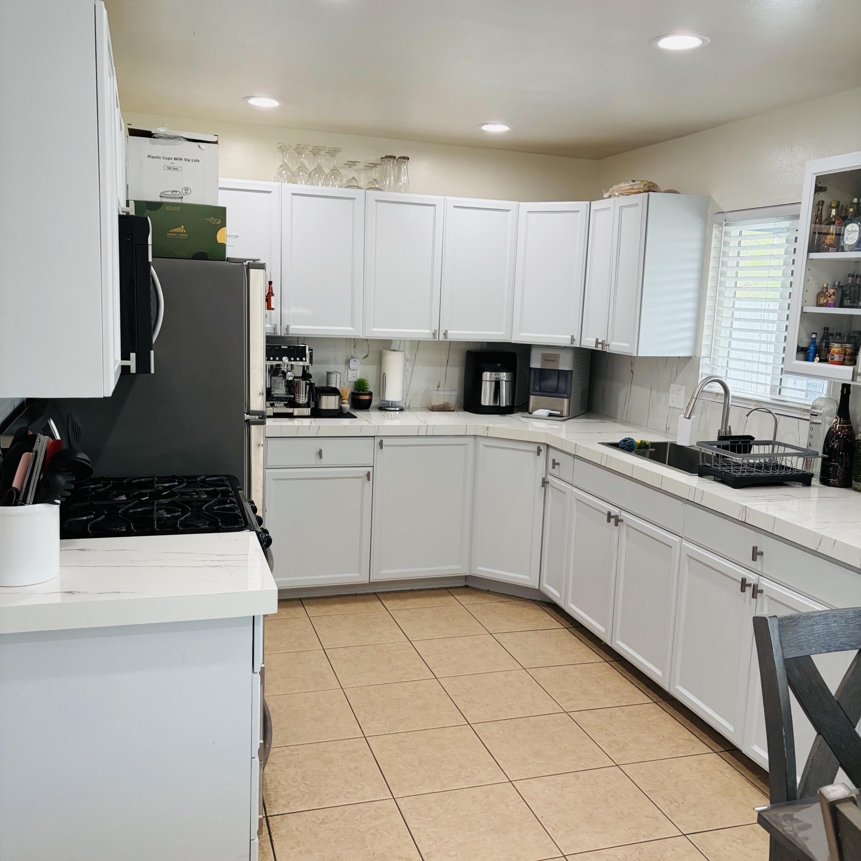 82165 Crest Avenue Indio, CA 92201 - Photo 9 of 37 a kitchen with a sink a stove and refrigerator