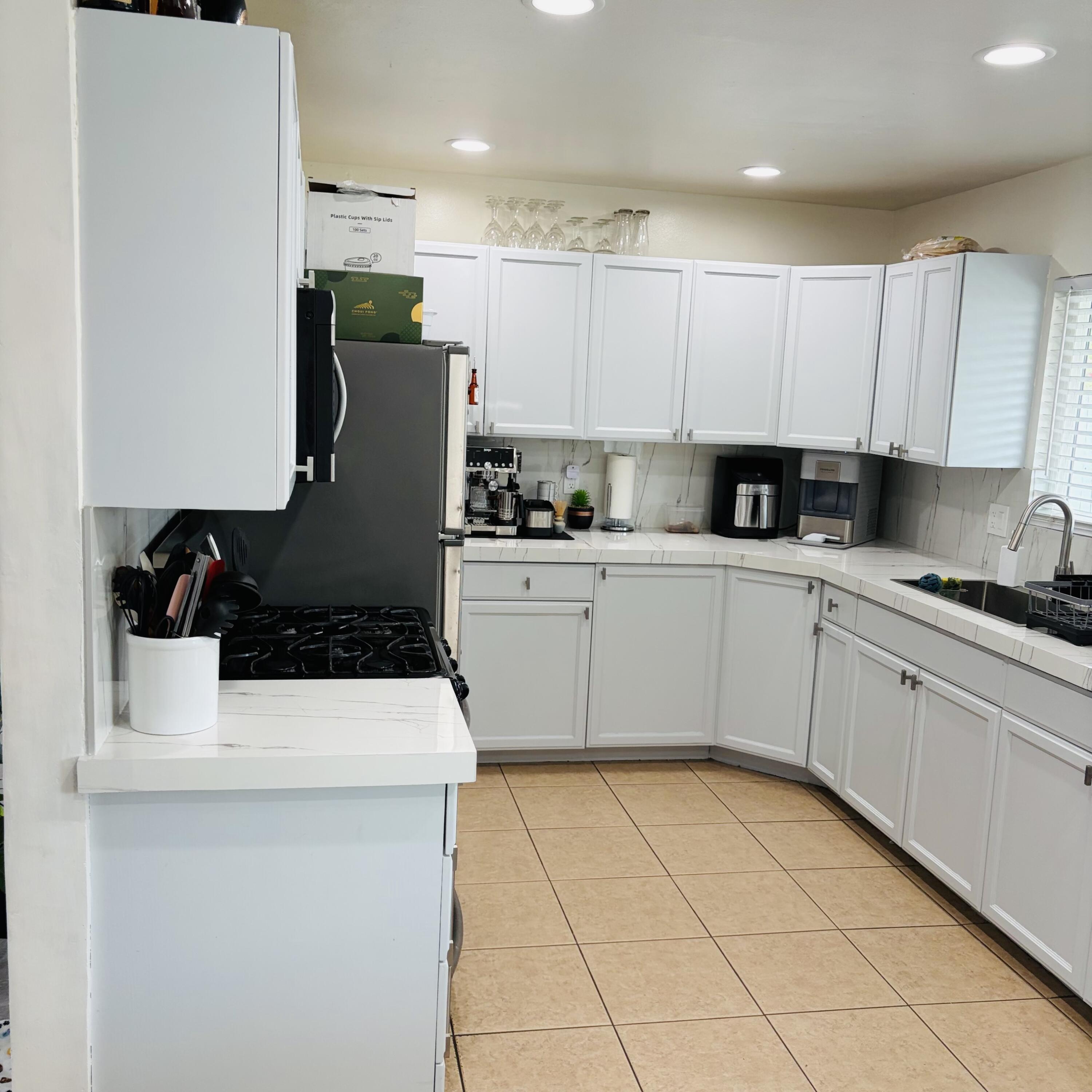 82165 Crest Avenue Indio, CA 92201 - Photo 10 of 37 a kitchen with a sink a stove and refrigerator