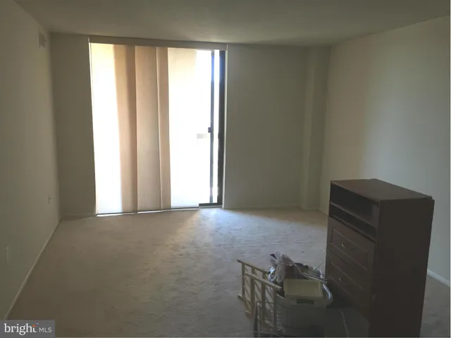 a view of an empty room and wooden floor