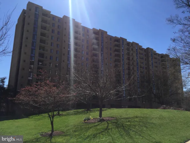 a view of a tall building with a yard