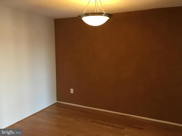 a view of a room with wooden floor and a chair