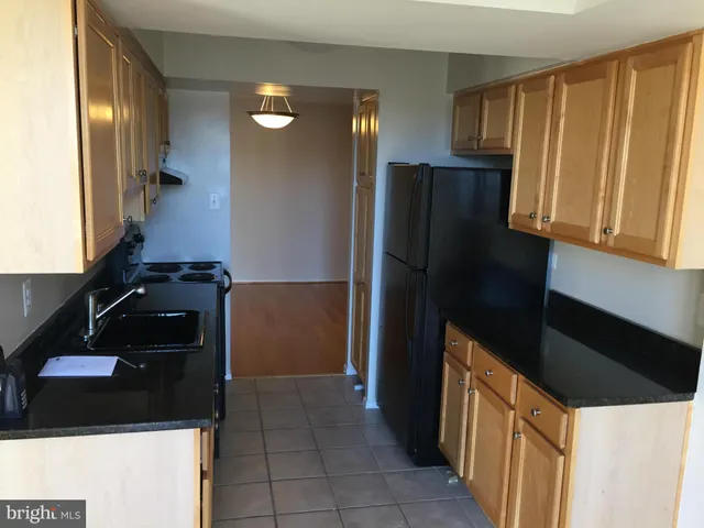 a kitchen with a refrigerator and a stove
