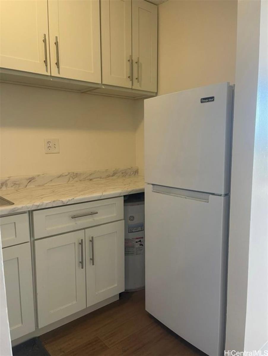 1560 Thurston Avenue, Unit 502 Honolulu, HI 96822 - Photo 5 of 9 a view of cabinets and wooden floor