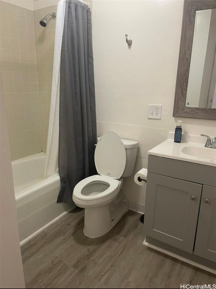 1560 Thurston Avenue, Unit 502 Honolulu, HI 96822 - Photo 6 of 9 a white toilet sitting next to a bathroom sink