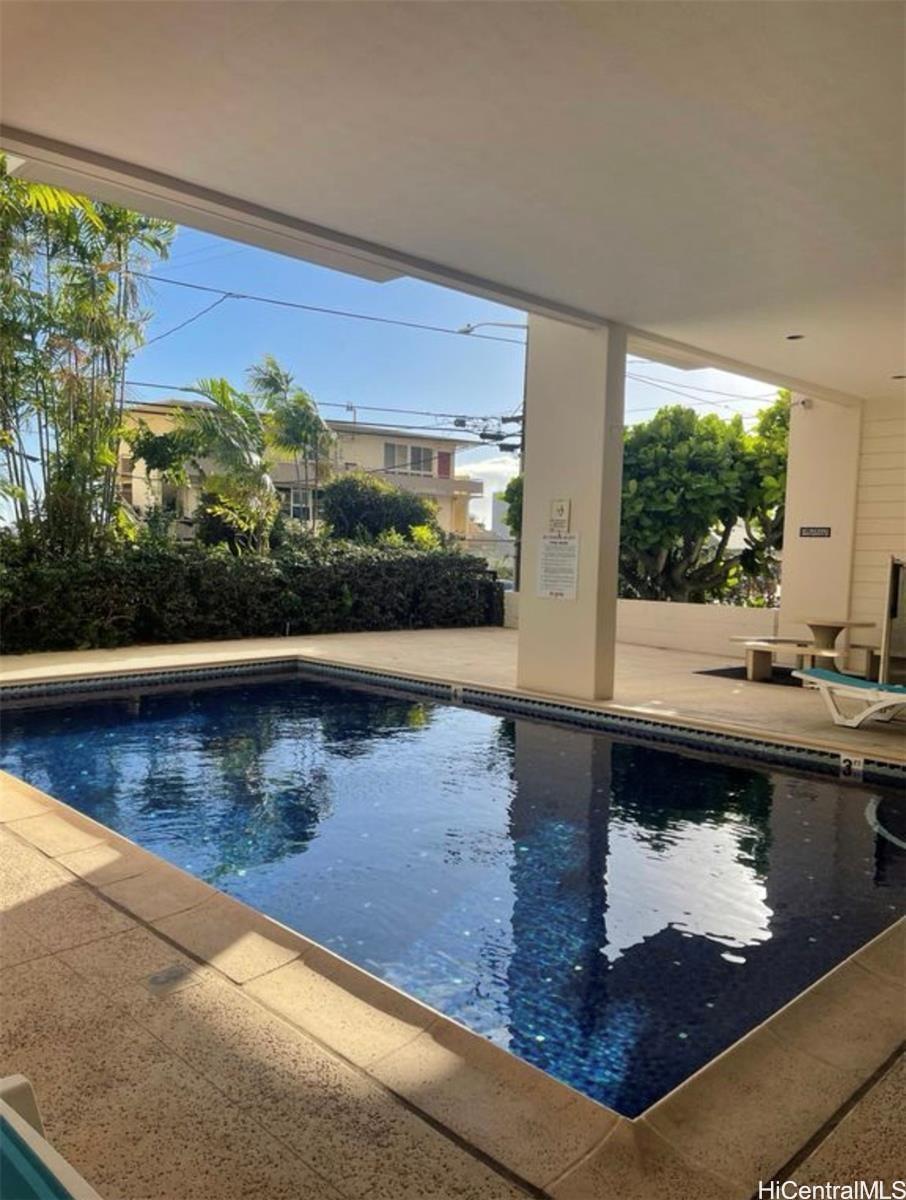 1560 Thurston Avenue, Unit 502 Honolulu, HI 96822 - Photo 9 of 9 a view of a floor to ceiling window and a swimming pool