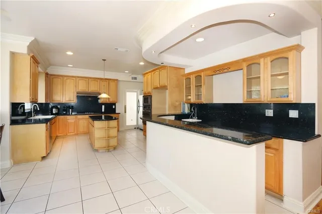 a kitchen with stainless steel appliances granite countertop a sink and a stove