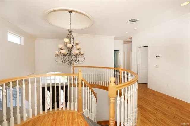 a view of staircase with railing and white walls
