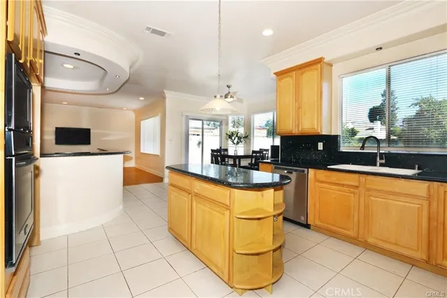 a kitchen with stainless steel appliances granite countertop a stove a sink and a refrigerator