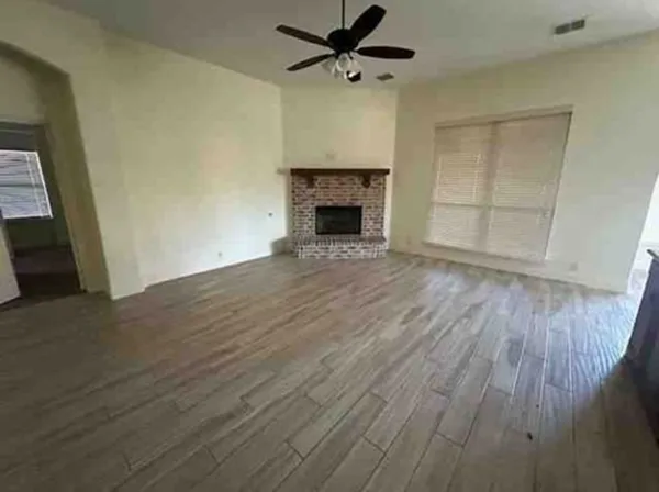 wooden floor fireplace and natural light in room