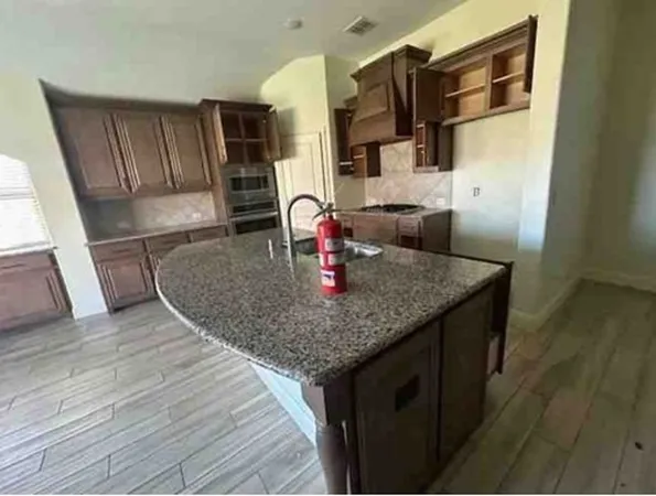 a kitchen with stainless steel appliances granite countertop a sink dishwasher and microwave