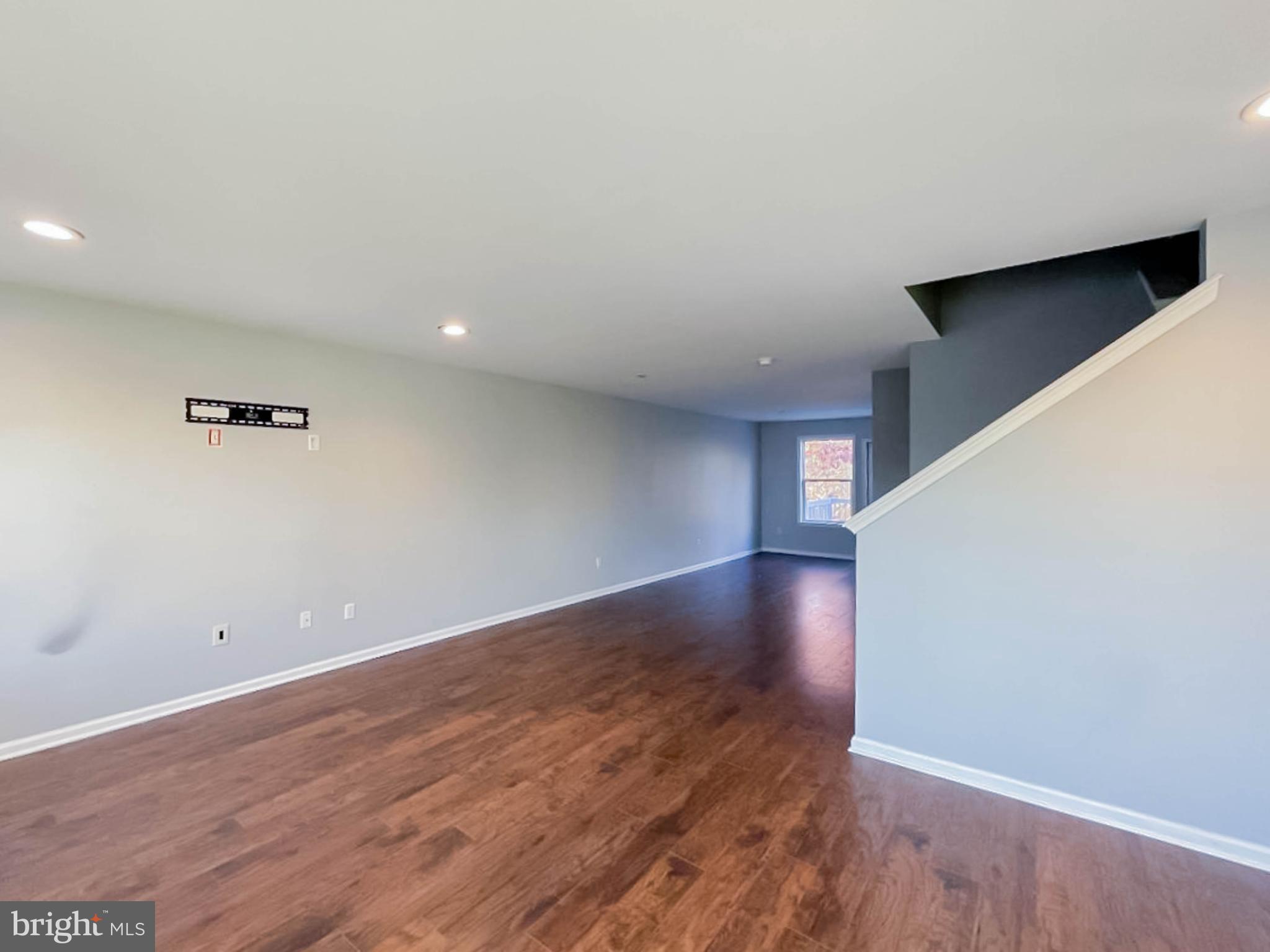 7 Tailor Lane Sicklerville, NJ 08081 - Photo 6 of 28 a view of an empty room with wooden floor and a window