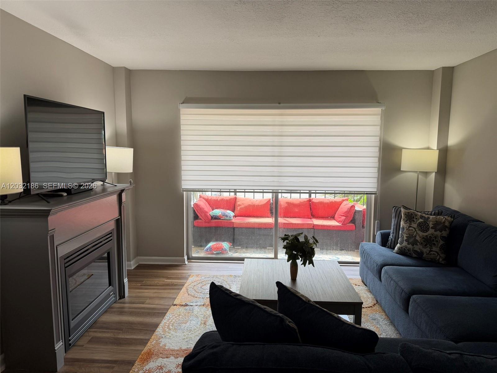 4164 Inverrary Drive, Unit 204 Lauderhill, FL 33319 - Photo 11 of 28 a living room with furniture a window and a flat screen tv