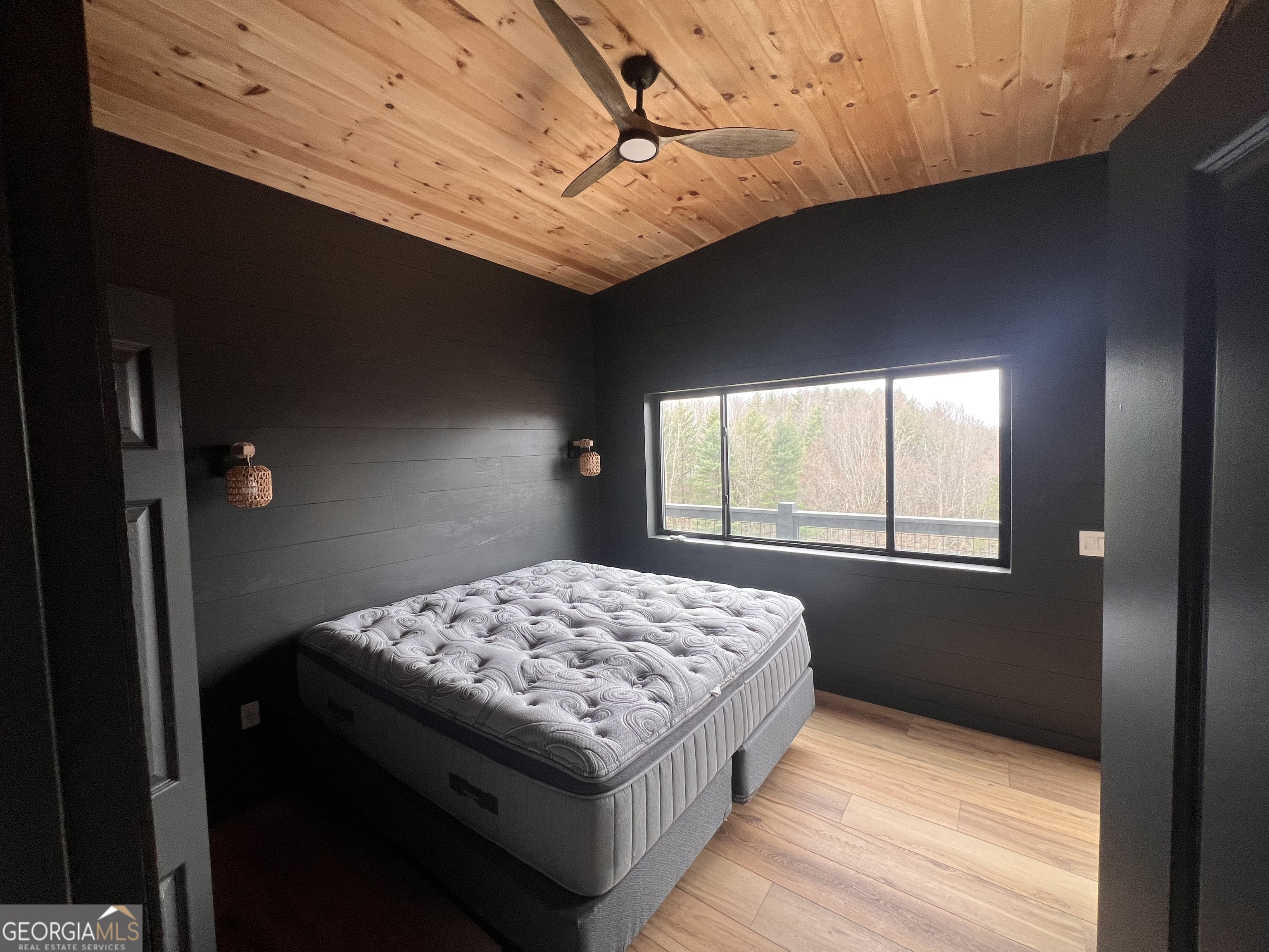 162 Dryman Ridge Road Scaly Mountain, NC 28775 - Photo 21 of 32 a bedroom with a bed and a window