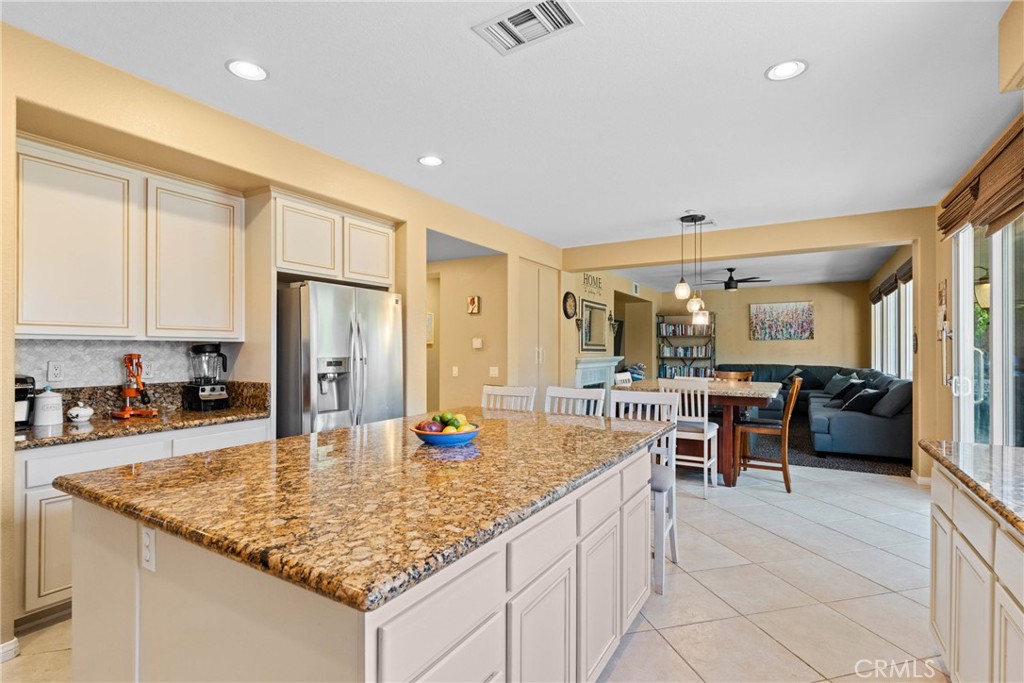 1137 Pamplona Drive Riverside, CA 92508 - Photo 19 of 50 a kitchen with stainless steel appliances granite countertop a sink refrigerator and cabinets