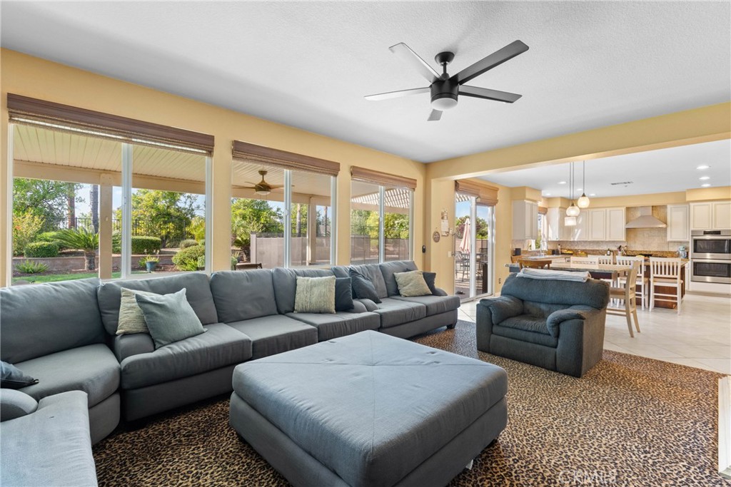 1137 Pamplona Drive Riverside, CA 92508 - Photo 23 of 50 a living room with furniture ceiling fan and a large window