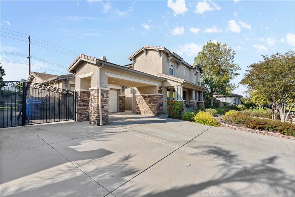 1137 Pamplona Drive Riverside, CA 92508 - Photo 3 of 50 a front view of a house with a yard and garage