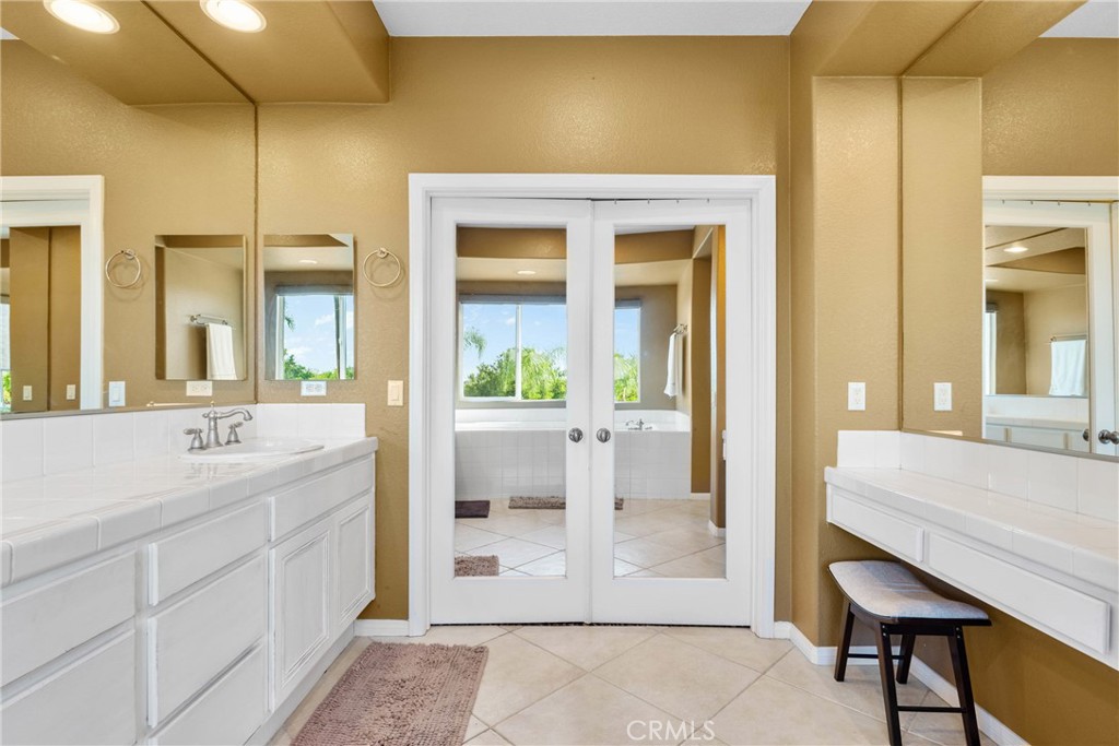 1137 Pamplona Drive Riverside, CA 92508 - Photo 31 of 50 a spacious bathroom with a granite countertop sink and a mirror