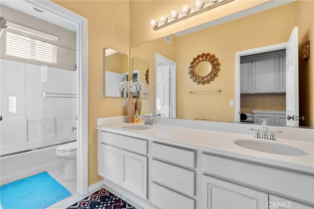 1137 Pamplona Drive Riverside, CA 92508 - Photo 36 of 50 a bathroom with a sink and a mirror