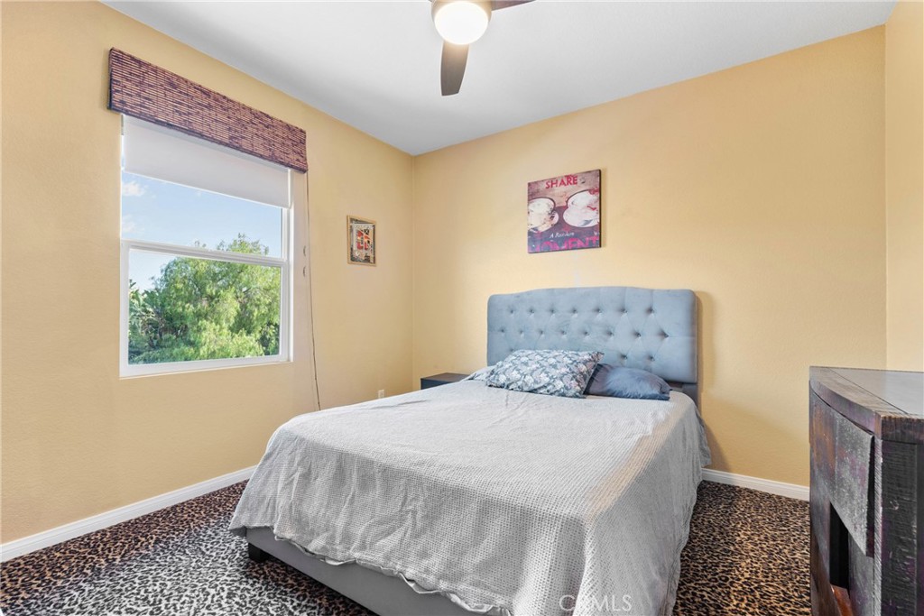 1137 Pamplona Drive Riverside, CA 92508 - Photo 37 of 50 a bedroom with a bed and a painting on the wall