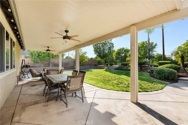 a view of a house with backyard porch and sitting area