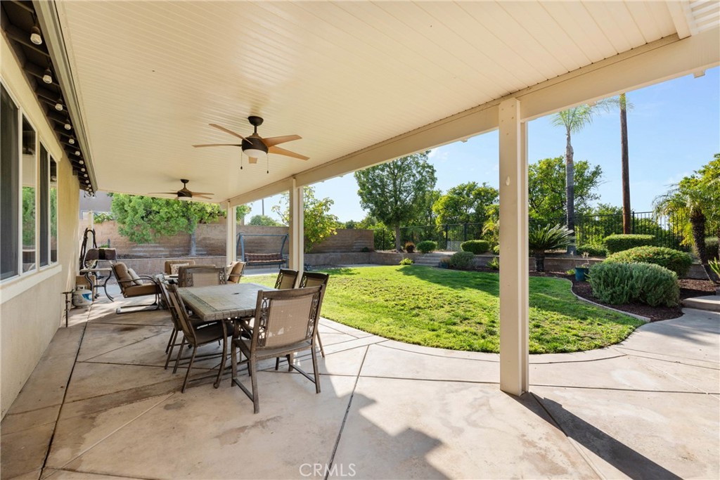 1137 Pamplona Drive Riverside, CA 92508 - Photo 38 of 50 a view of a patio with a table chairs and a yard