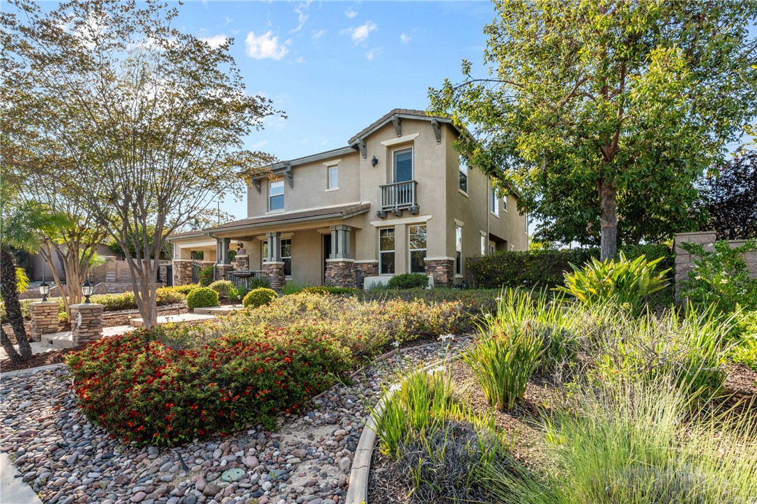 1137 Pamplona Drive Riverside, CA 92508 - Photo 4 of 50 a front view of a house with a yard and shrubs