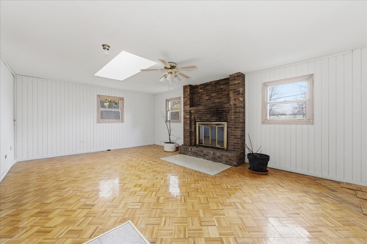 6N879 Dunham Road Wayne, IL 60184 - Photo 14 of 27 a view of an empty room with a fireplace and a window