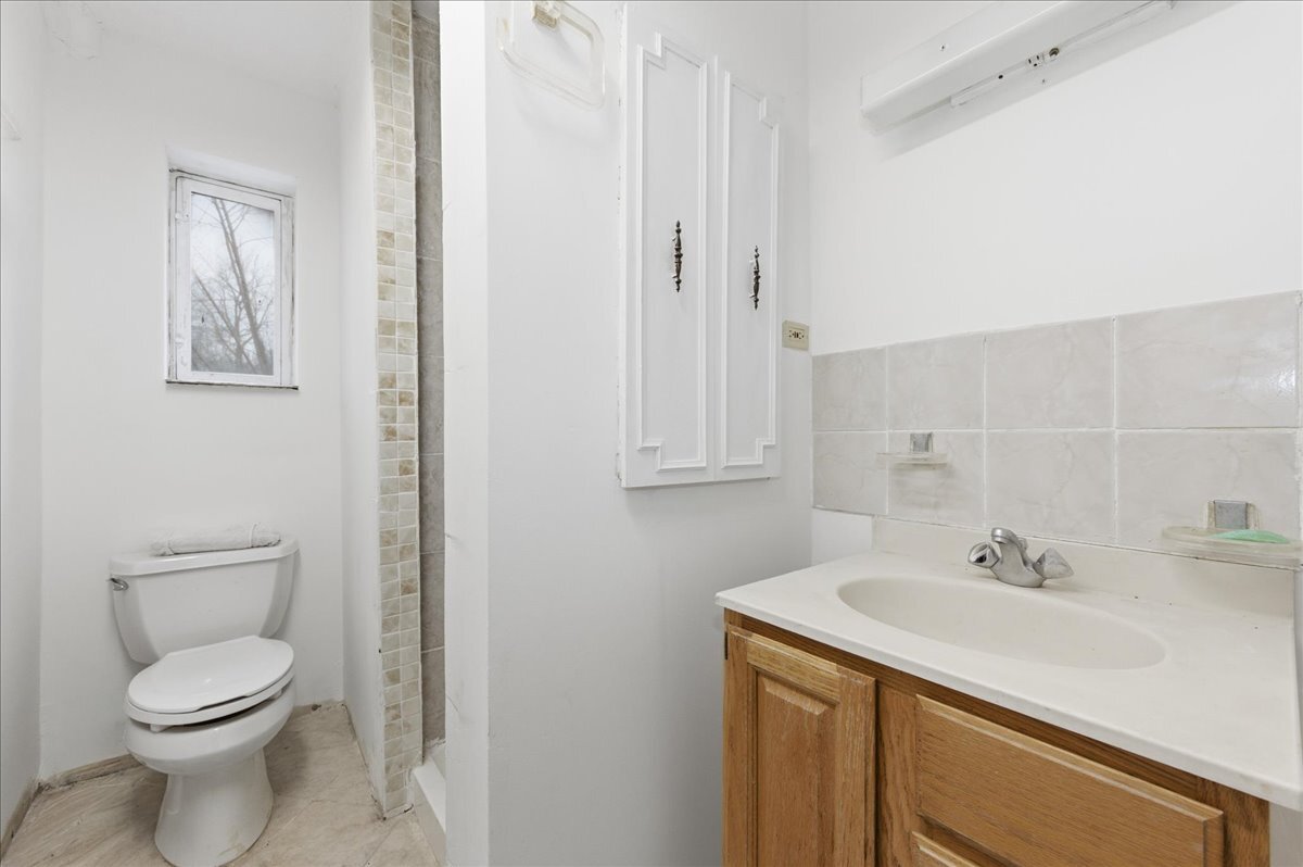 6N879 Dunham Road Wayne, IL 60184 - Photo 19 of 27 a bathroom with a sink toilet and vanity