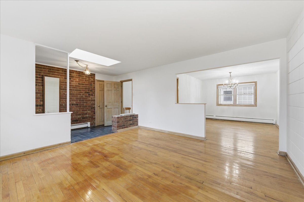 6N879 Dunham Road Wayne, IL 60184 - Photo 6 of 27 a view of an empty room with a window and wooden floor