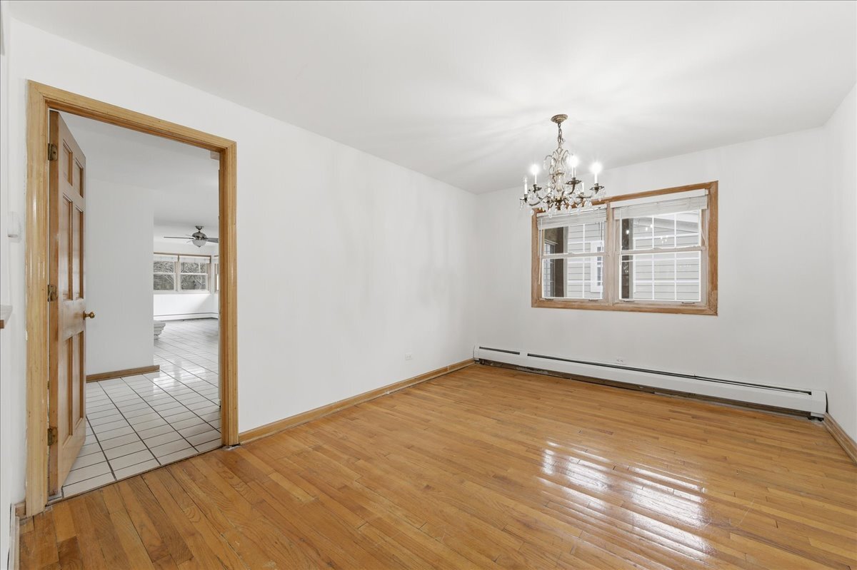 6N879 Dunham Road Wayne, IL 60184 - Photo 7 of 27 a view of an empty room with window and wooden floor