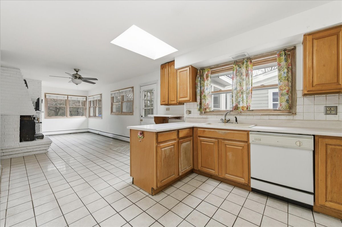 6N879 Dunham Road Wayne, IL 60184 - Photo 10 of 27 a kitchen with stainless steel appliances granite countertop a sink and cabinets