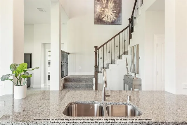 a kitchen with refrigerator and cabinets