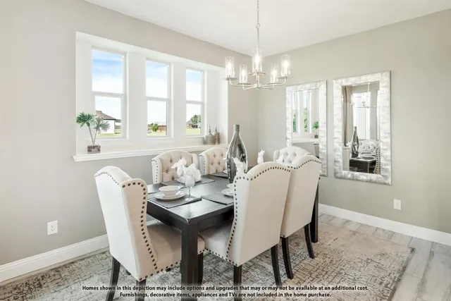 a dining room with furniture a chandelier and wooden floor