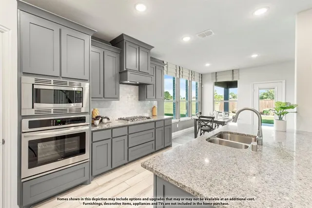 a kitchen with a table chairs stove and white cabinets