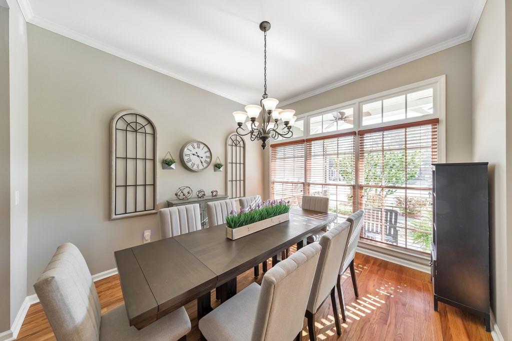 304 Turning Leaf Court Canton, GA 30115 - Photo 15 of 73 a view of a dining room with furniture a chandelier and wooden floor