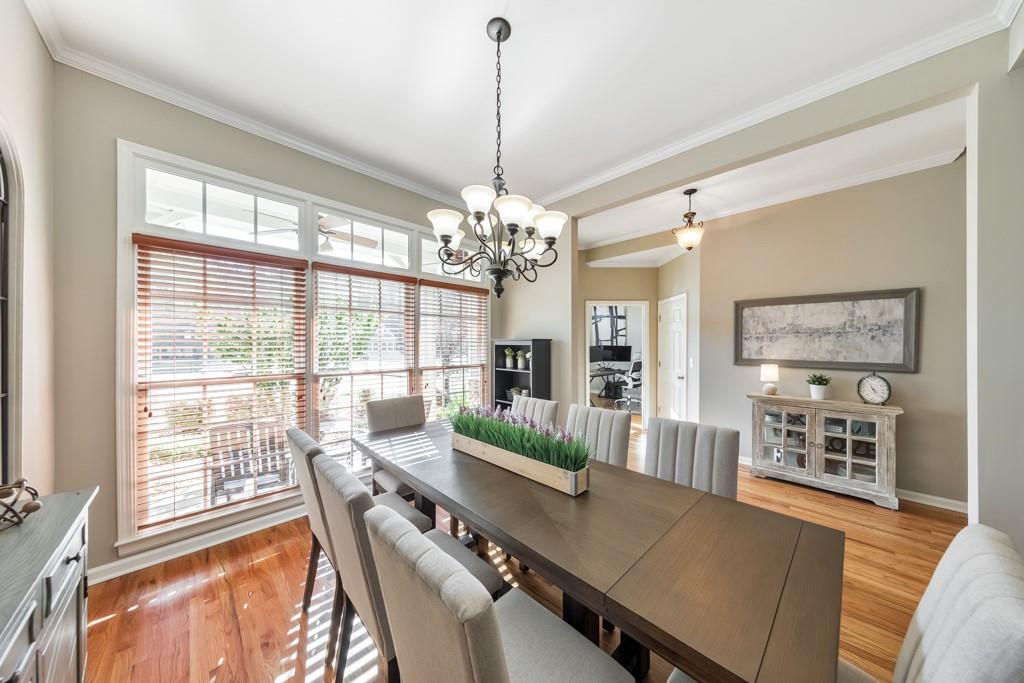 304 Turning Leaf Court Canton, GA 30115 - Photo 16 of 73 a view of a dining room with furniture a chandelier and wooden floor