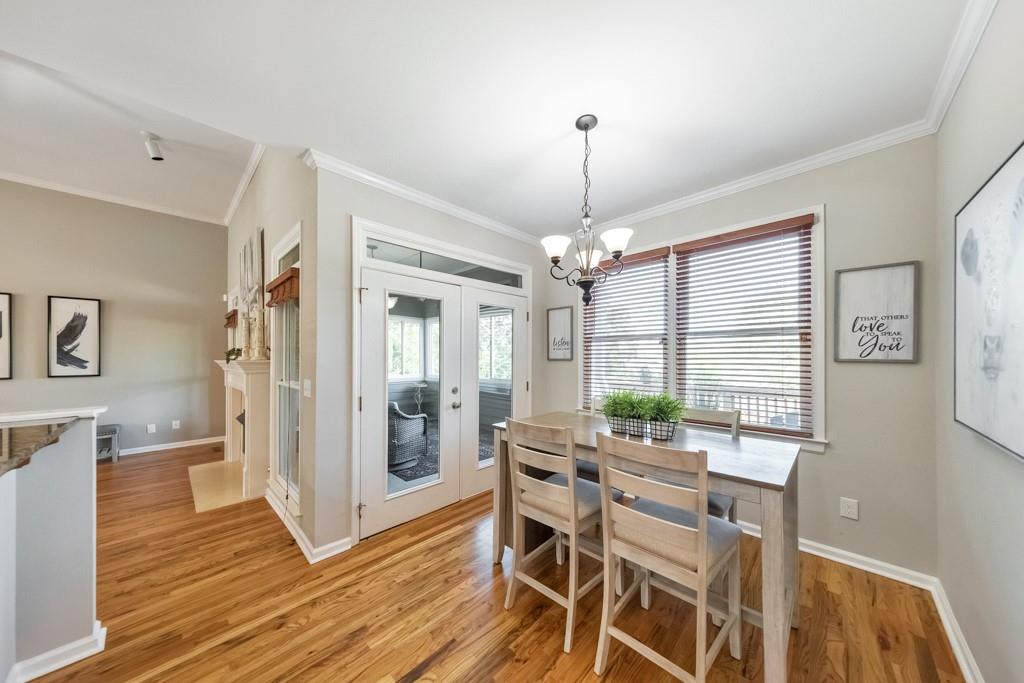 304 Turning Leaf Court Canton, GA 30115 - Photo 20 of 73 a view of a dining room with furniture wooden floor and chandelier
