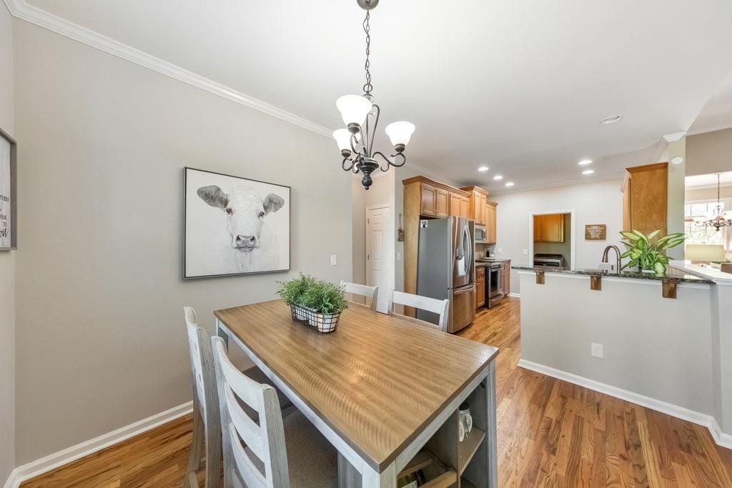 304 Turning Leaf Court Canton, GA 30115 - Photo 22 of 73 a view of a dining room and livingroom with furniture wooden floor a chandelier