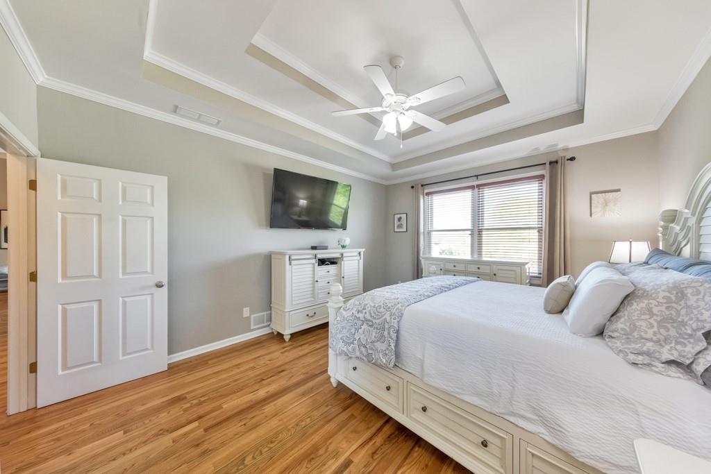 304 Turning Leaf Court Canton, GA 30115 - Photo 24 of 73 a bedroom with a bed flat screen tv and a window